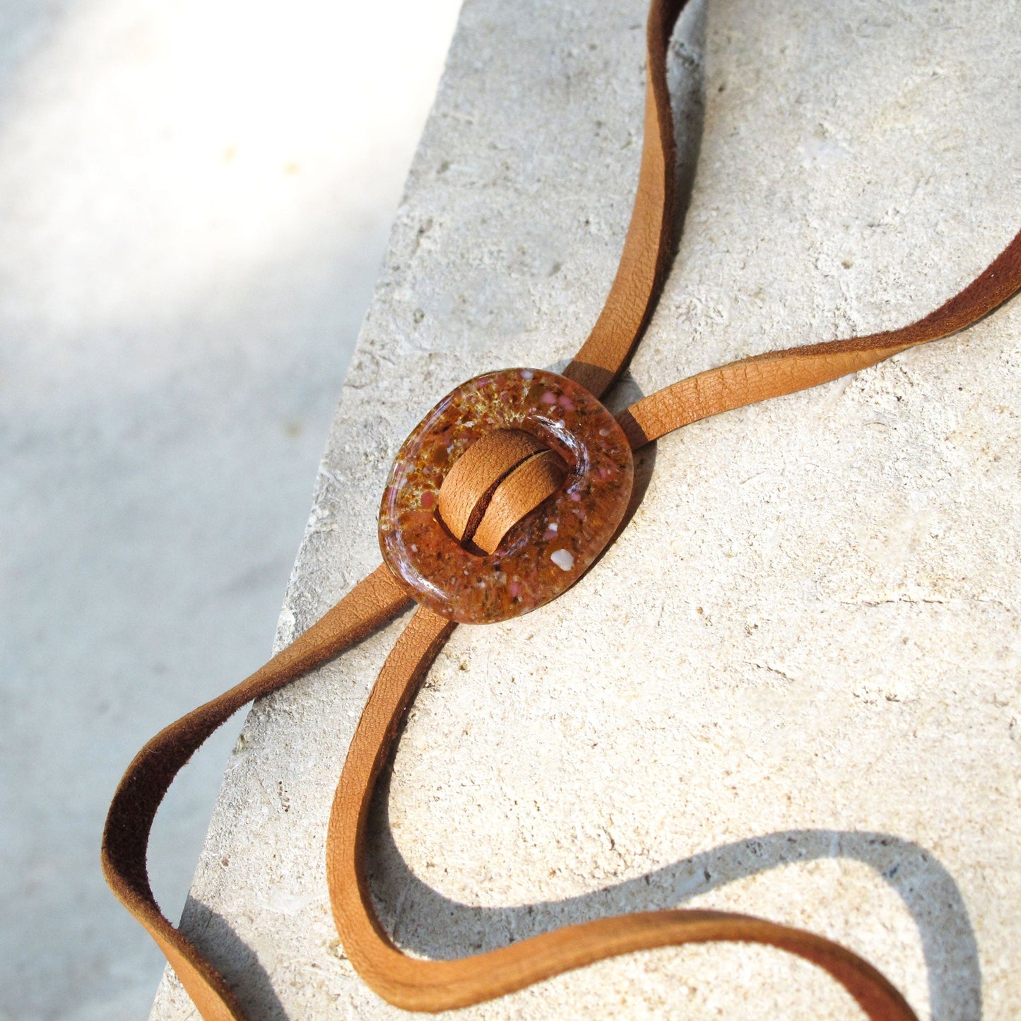 Close up of Katie Kismet Stone Lariat Bolo Tie in Amber for men and women