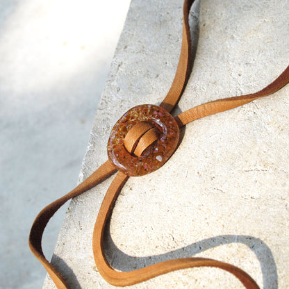 Close up of Katie Kismet Stone Lariat Bolo Tie in Amber for men and women